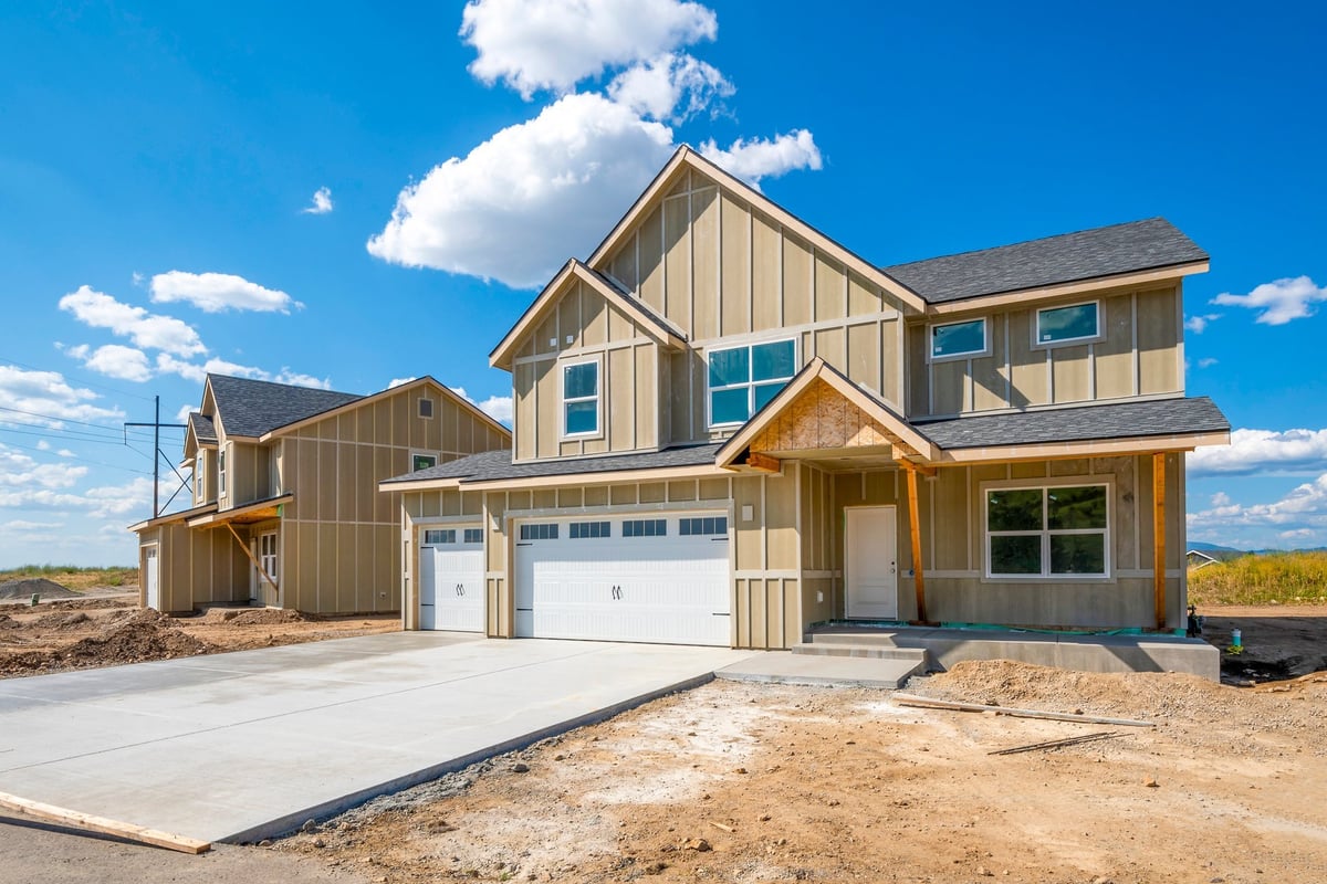 Street of partially finished new homes in a suburban development