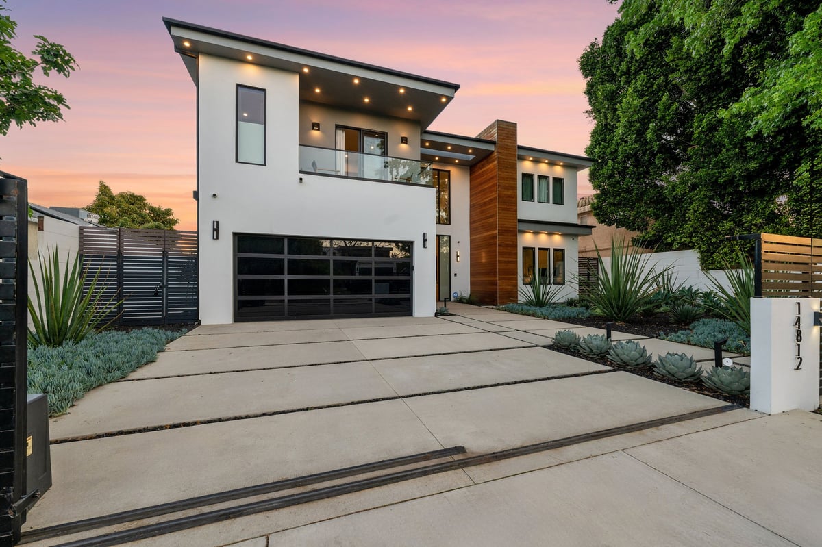 Modern luxury home with pool and patio at twilight showcasing sleek architectural design